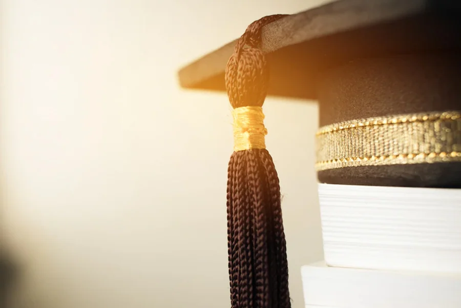 Graduation cap on academic books